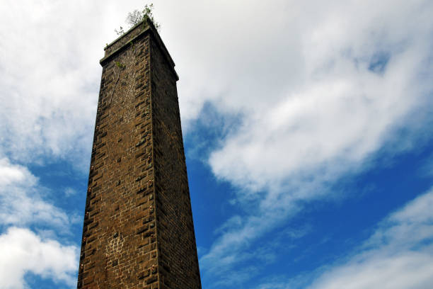 L'Escalier, Grand Port, Mauritius: old furnace and chimney, Savannah sugar plantation, roadside view - there are more than 250 old abandoned mill chimneys in Mauritius. Such towering chimneys were needed for the furnaces to efficiently burn the sugarcane bagasse, which was the fuel used to power the sugar mills.