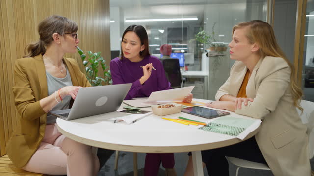 Three women having a meeting for a project in the meeting room