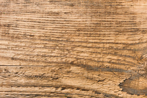 Empty rustic wooden table background. Old wood table with dark blurred background. Mock up.