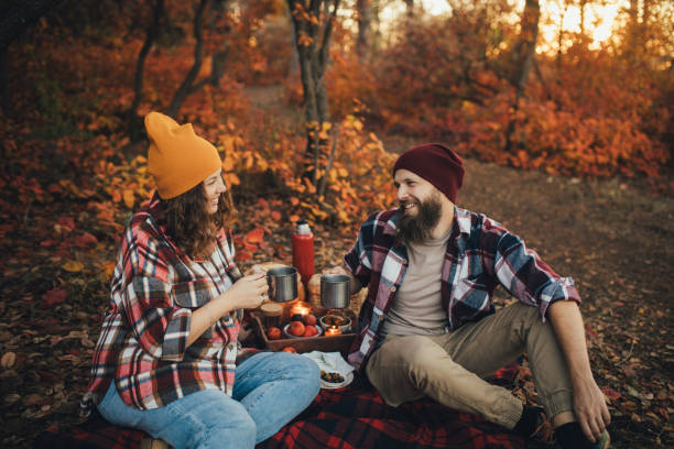 istock Happy couple drinking tea from thermos in an autumn forest. 2027474663