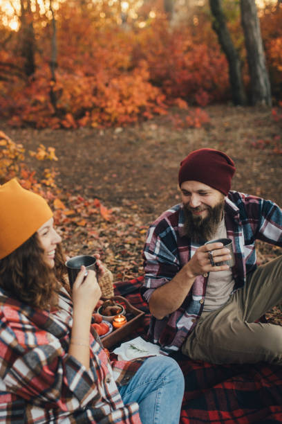 istock Happy couple drinking tea from thermos in an autumn forest. 2027474664