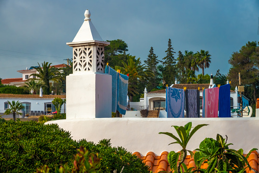 Quintessential Algarve: Algarvian chimneys, drying clothes and subtropical vegetation, Portugal