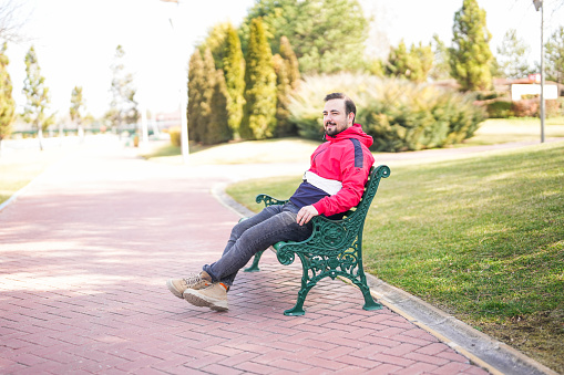 man sitting on bench in quiet park in city center