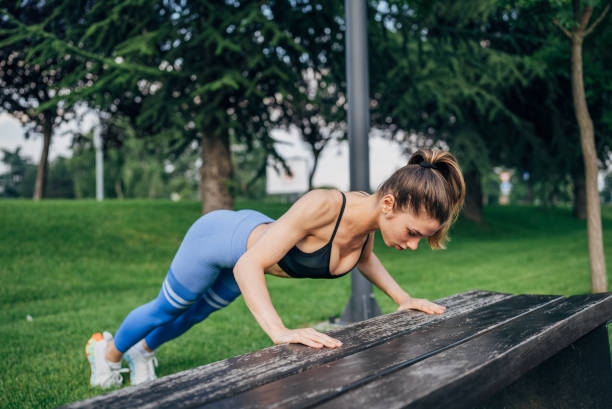 istock Fit young woman doing push-ups 2027519909