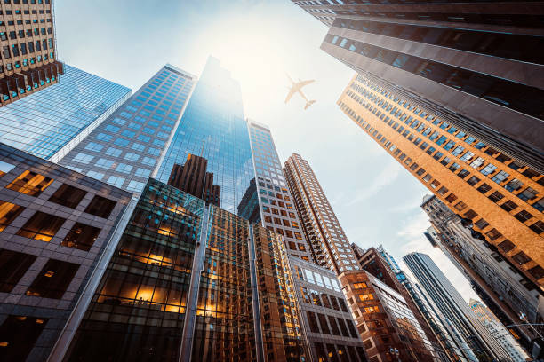 istock Business towers with a airplane silhouette 2027526175