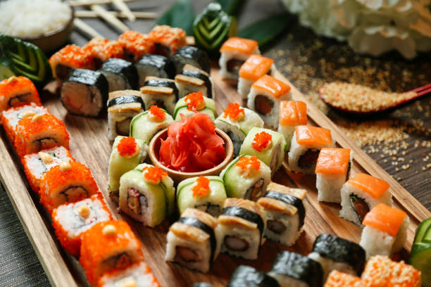 istock Wooden Tray Topped With Assorted Sushi Rolls 2027538844