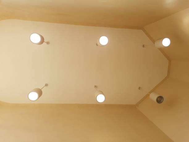 istock Five light bulbs are on and one is off in a yellow ceiling 2027553997