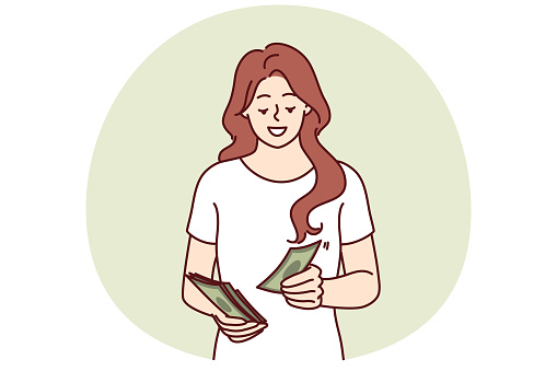 Successful woman counts money earned in business or received from dividend investments with good profit. Smiling girl with cash saves money wanting to make pension contribution or pay taxes