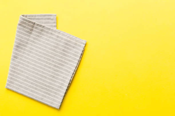 istock top view with gray kitchen napkin isolated on table background. Folded cloth for mockup with copy space, Flat lay. Minimal style 2027566250