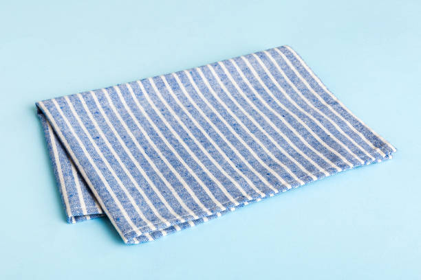 istock top view with blue kitchen napkin isolated on table background. Folded cloth for mockup with copy space, Flat lay. Minimal style 2027566254