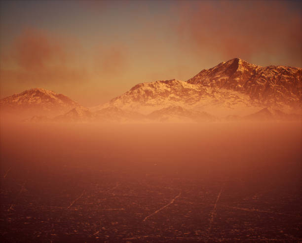 istock Frozen lake with snow mountains in mist under sunset sky with some clouds. 2027569974