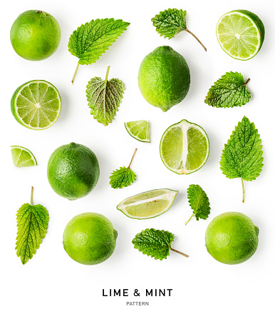 Fresh lime fruit and mint leaf pattern isolated on white background. Healthy eating and food concept. Creative layout. Citrus fruits composition. Top view, flat lay. Design element