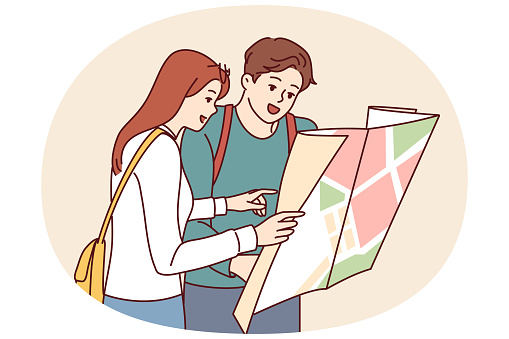 Tourist couple of man and woman looking at map choosing new city for travel or searching for hotel location. Guy and girl travel to new places enjoying vacation together on summer weekend