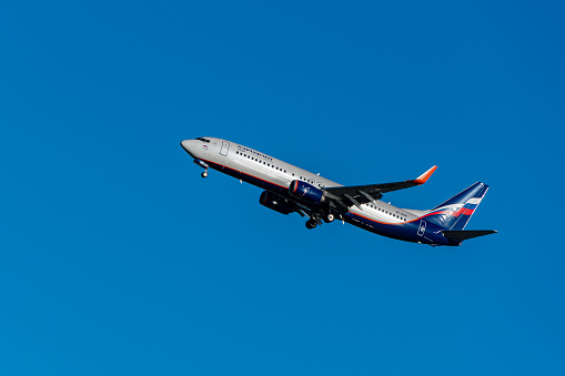 Boeing 737-800 takes off against blue spring sky from Adler Airport. Close-up. AEROFLOT - RUSSIAN AIRLINES. VP-BSB. Aircraft landing gear and flaps extended. Sochi, Russia - May 18, 2021