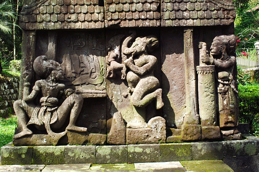 Bas-relief sculptures on wall at encased foot of Sukuh Temple, ancient historical heritage site in central Java  - Indonesia