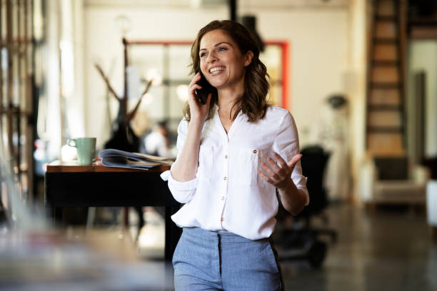 istock Young smiling woman using the phone. 2027627239