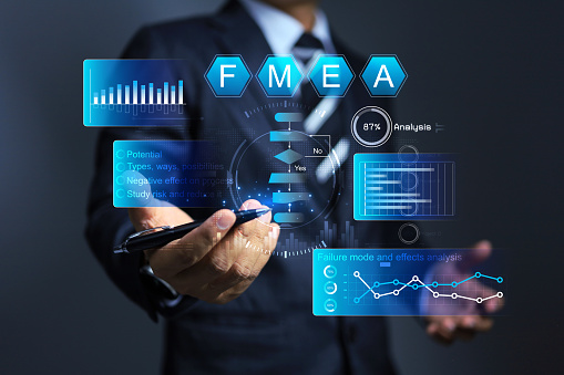 Businessman working with FMEA or failure mode and effect analysis to analyze cause of problem and find way to reduce and improve work process to better, raising production levels and reducing waste