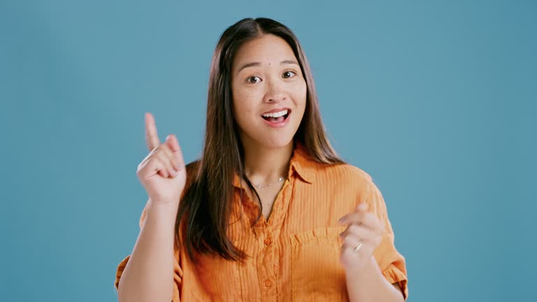 Confused, thinking and woman face with idea in studio for solution, insight or conclusion on blue background. Why, doubt and Japanese model portrait with questions, answer or problem solving memory
