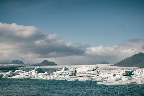 Icebergs floating  in the Jokulsalon glacier lagoon in Iceland during a summer day. The Jökulsárlón Glacier Lagoon is a stunning glacial lake in Iceland, located in the southeastern part of Iceland, near Vatnajökull National Park.