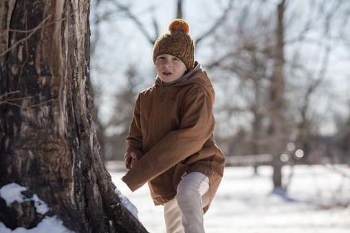 Winter portrait of kid boy. Active outoors leisure with children in winter.