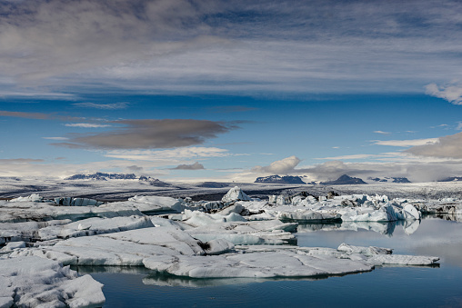 Icebergs floating  in the Jokulsalon glacier lagoon in Iceland during a summer day. The Jökulsárlón Glacier Lagoon is a stunning glacial lake in Iceland, located in the southeastern part of Iceland, near Vatnajökull National Park.
