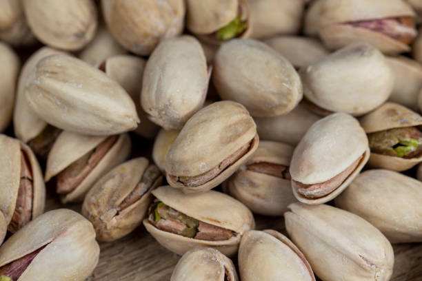 istock Salted fried pistachios on the table 2027654789