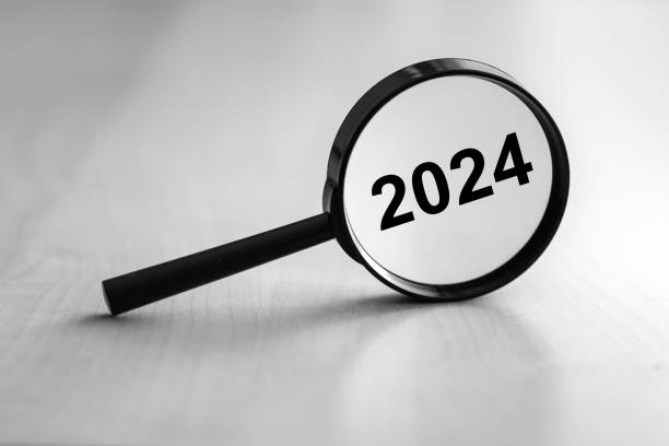 istock Black magnifying glass shows the year 2024 2027658649