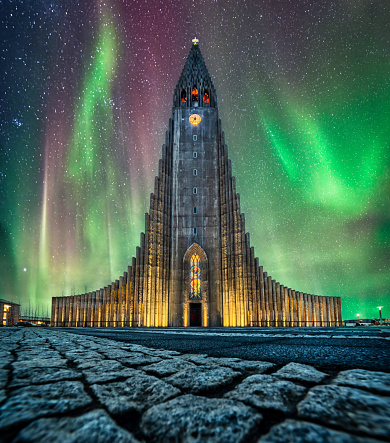 Night photo of the Aurora borealis above hallgrimskirkja church in central of reykjavik city in 2024. Iceland