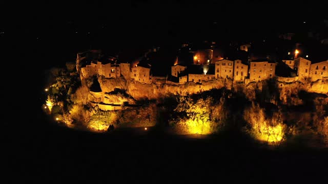 Night shot of Pitigliano city in the Tuscany region of Italy. Static drone shot.