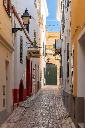 Ciutadella, Spain - 26 January, 2024: narrow cobblestone street in the historic center of Ciutadella on Menorca Island