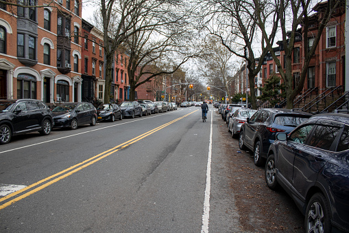 nyc, United States – February 01, 2024: A serene street scene in New York with parked cars on both sides of the road
