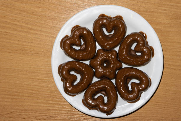 Handmade heart-shaped cookie with red, pink and white colors.