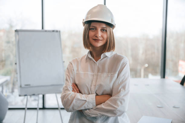 istock Young woman architect in hard hat is in office 2027738712