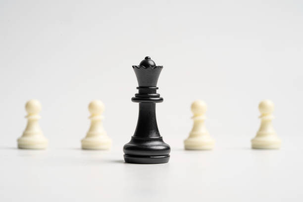 Human hand holding chess king on white background.