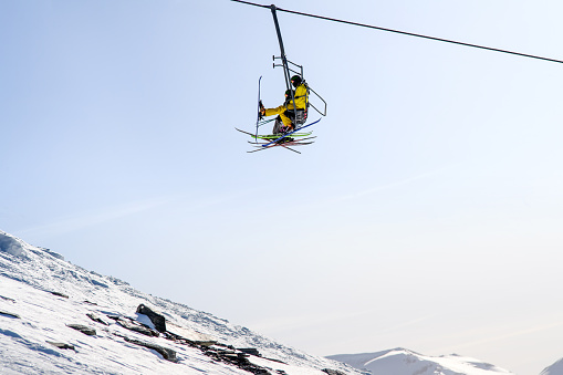 2 skiers on a chairlift