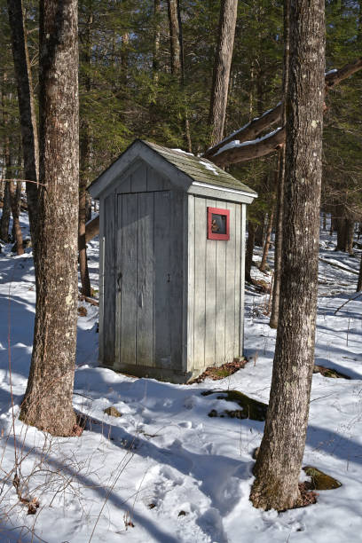 Man in hurry entering old wooden outhouse