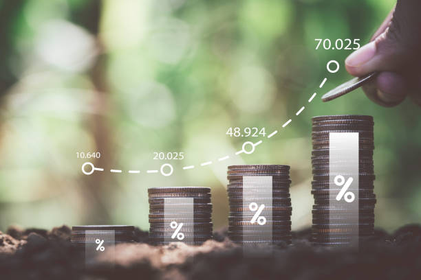 istock Hand stacking increasing coins with graph chart for money deposit saving to dividends profit growth concept. 2027777474