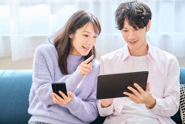 istock A man and a woman comparing smartphone and tablet PC screen 2027784405