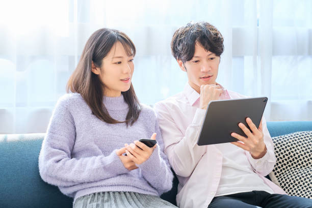 istock A man and a woman comparing smartphone and tablet PC screen 2027785967