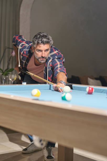 istock Focused mature Hispanic man playing pool 2027789654