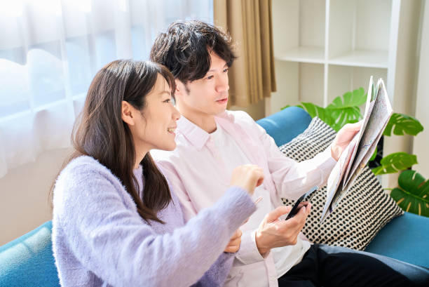 istock A man and a woman talking with a map and smartphone 2027791214
