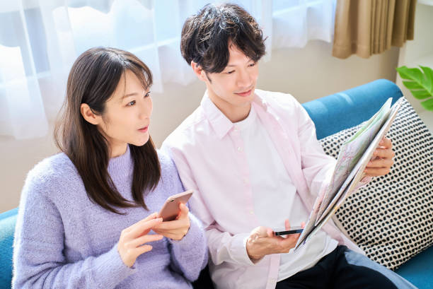 istock A man and a woman talking with a map and smartphone 2027795917