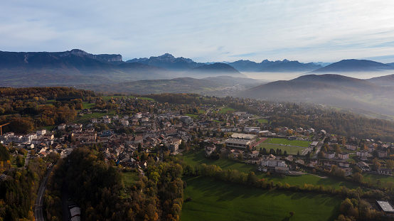 Drone shot aerial view of village and mountain hill street direction of garden and town house building sunset france,Drone flight above village, in south of France, with the mountain on the background surrounded by forest.
