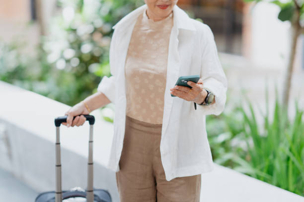 istock Businesswoman using smartphone on the go 2027802243