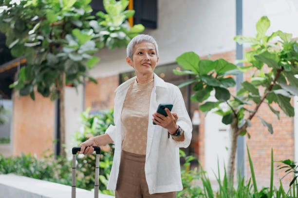 istock Businesswoman using smartphone on the go 2027802247
