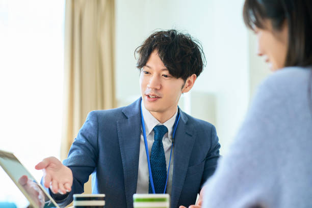 istock A man in a suit talking to a woman 2027802779
