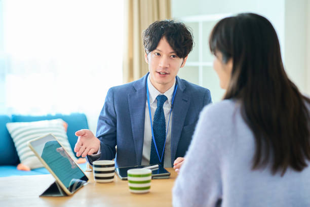 istock A man in a suit talking to a woman 2027805416