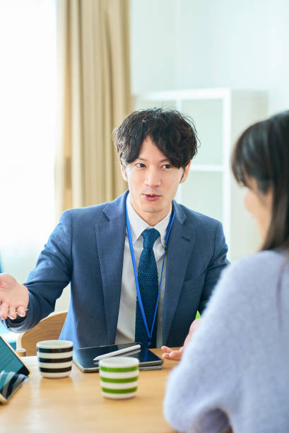 istock A man in a suit talking to a woman 2027805950