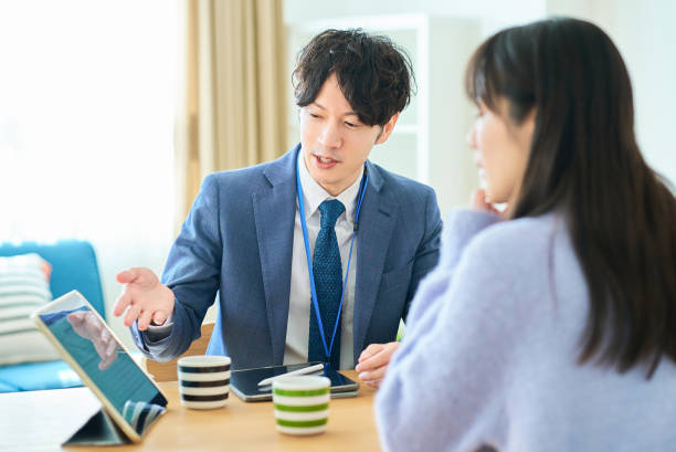 istock A man in a suit talking to a woman 2027808052