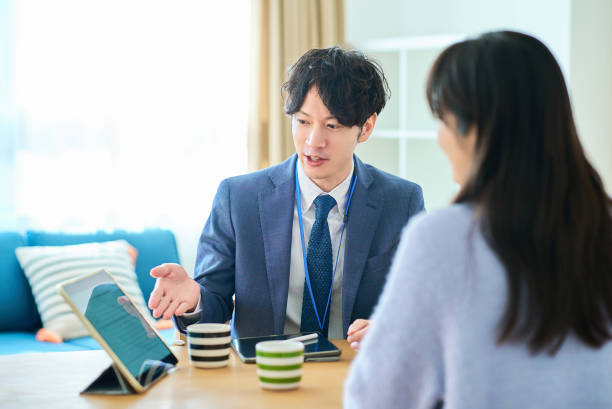 istock A man in a suit talking to a woman 2027808586